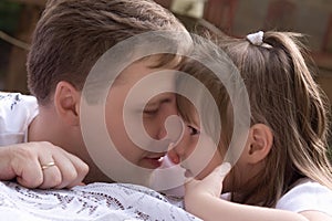 father kisses his small daughter