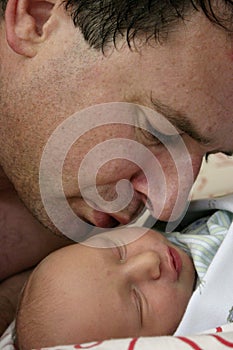 Father kissing infant