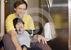 Father on kitchen floor with disabled son