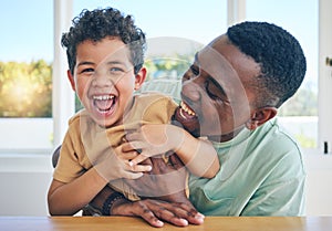 Father, laugh and black man tickle son, have fun and enjoy happy quality time together in Jamaica home. Family bonding