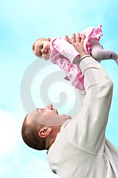 Father lifts his baby girl