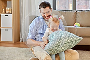 Father with little baby daughter at home