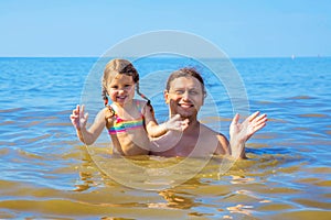 Father and little baby daughter swimming in the sea.