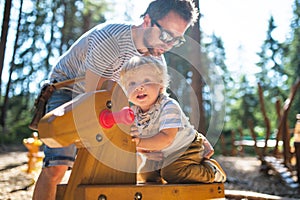 Father with little boy on the playground.