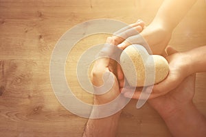 Father and little child holding together wooden heart. Happy father`s day concept