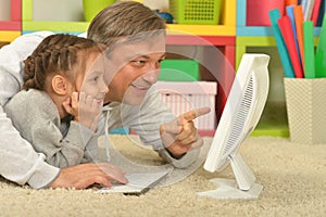 Father and little daughter with computer