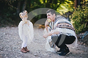 Father and little daughter eating pears