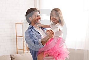 Father and little daughter having dance lesson