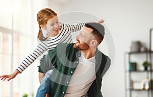 Father and little daughter having fun at home