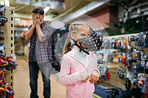 Father and little daughter having fun in petshop photo