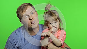 Father and little daughter making faces to camera. Chroma Key. Fathers day