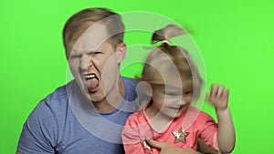 Father and little daughter making faces to camera. Chroma Key. Fathers day