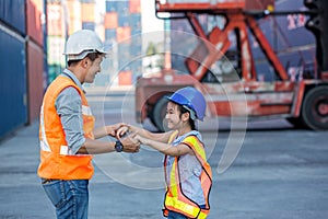 Father and little daughter wearing a safety helmet at Container cargo site. Business heir concept. Happy father and daughter weari