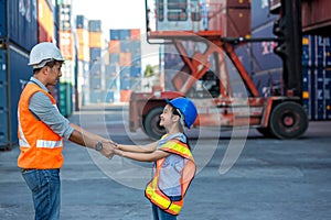 Father and little daughter wearing a safety helmet at Container cargo site. Business heir concept. Happy father and daughter weari