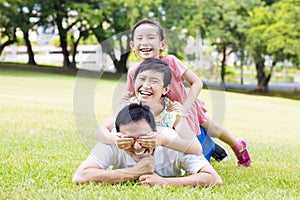 father and little girl lying on the grass