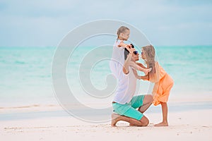 Father and little kids on the beach