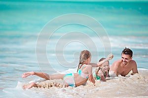 Father and little kids enjoying beach summer tropical vacation