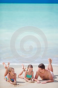 Father and little kids enjoying beach summer tropical vacation. Family playing on the beach