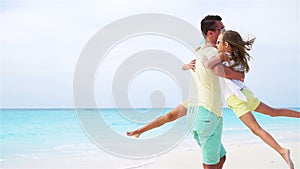 Father and little kids on white tropical beach have a lot of fun. slow motion