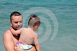 Father and little son on the beach