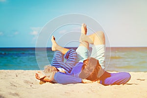 Father and little son play on beach