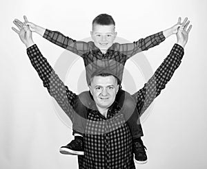 Father little son red shirts family look outfit. Child riding on dads shoulders. Happiness being father of boy. Having