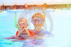 Father and little son snorkeling on tropical beach