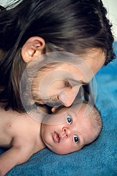 Father long hair kissing his son