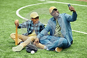 Father making selfie with son after game