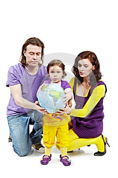 Father, mother and daughter hold ball-earth