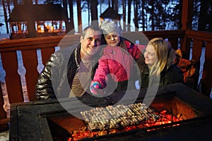 Father, mother and daughter near brazier with