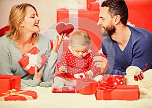 Father, mother and doughter child. Valentines day. Red boxes. Love and trust in family. Bearded man and woman with