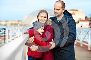 Father and mother with his son walking outdoor. Child hugging dad. Family Love concept. spring.