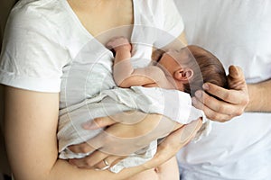 Father and mother with a newborn son. New multi-generation young family