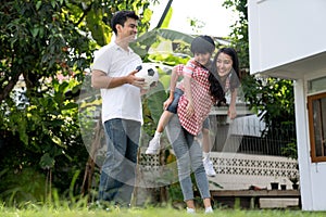 Father and mother playing with children outside.