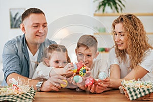 Father, mother, son and daugher. Happy family celebrating Easter holidays together