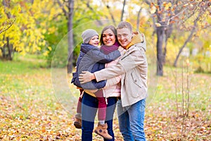 Father and Mother With Young Son On hands Autumn Park