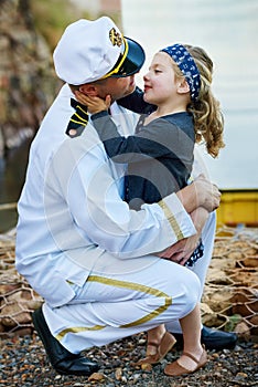 Father, navy and child hug with love for family reunion at sea dock or goodbye as captain sailor, daughter or service