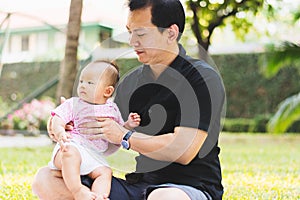Father parenting baby on park