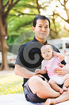 Father parenting baby on park