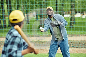 Father playing baseball together with his son