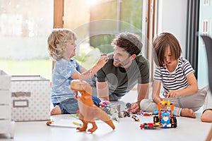 Father playing with his children at home