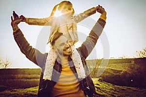 Father playing with his daughter in the park.