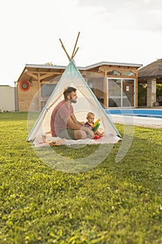 Father playing with his son in the backyard