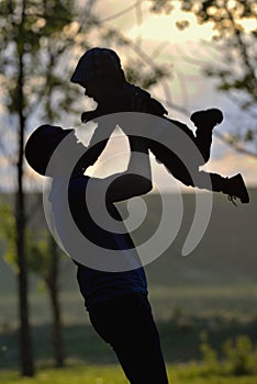 Father playing with his son in forest