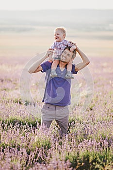 Father playing with his son in a lavender field