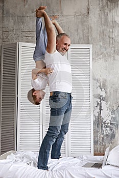 Father plays with son at home. They are home on self-isolation.