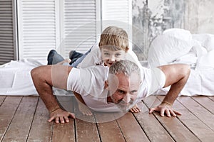 Father plays with son at home. They are home on self-isolation.