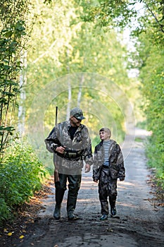 Father pointing and guiding son on first deer hunt