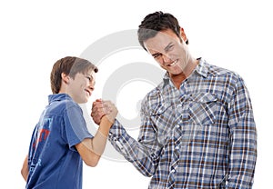 Father, portrait and arm wrestle with child for game of strength, power or playful bonding on a white studio background photo